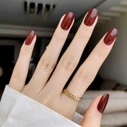 hand model wearing Gelly Nail Kit in colour Crimson Crush - a deep glossy red